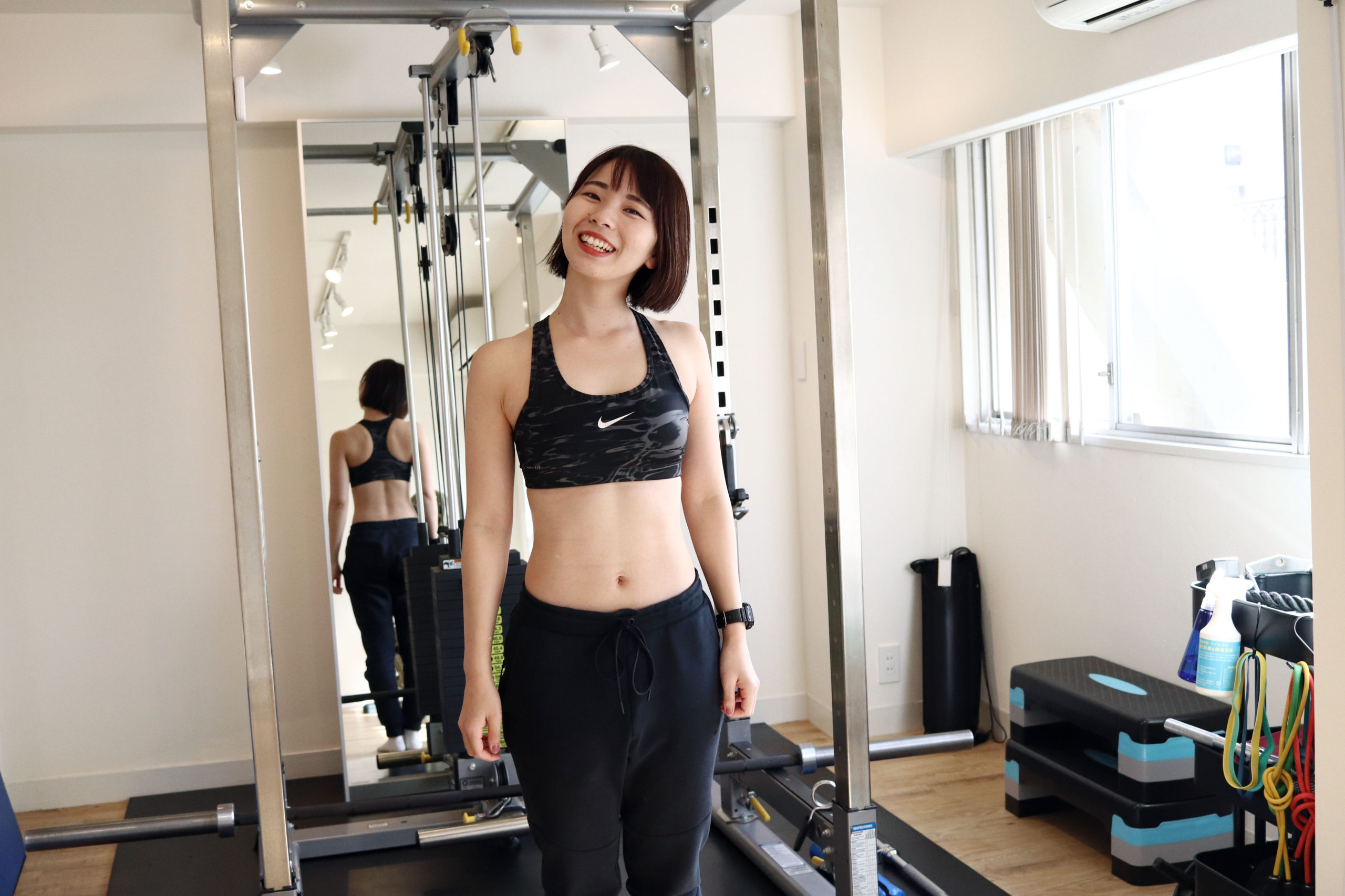 トレーニングウェアを着て笑顔を見せる長谷川トレーナー